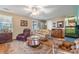 Inviting living room featuring hardwood floors, comfortable seating, and natural light at 634 Melody Ln., Surfside Beach, SC 29575