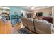 Cozy living room with hardwood floors, a ceiling fan, comfortable seating, and an aquarium at 634 Melody Ln., Surfside Beach, SC 29575