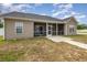 Backyard with a patio, screened porch, and well-maintained lawn, offering ample space for outdoor activities at 6392 Highway 378, Conway, SC 29527
