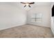 Bright bedroom with neutral carpet, ceiling fan, and a large window offering plenty of natural light at 6392 Highway 378, Conway, SC 29527