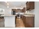 Well-lit kitchen featuring dark wood cabinets, stainless steel appliances, and a center island with pendant lighting at 6392 Highway 378, Conway, SC 29527