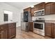 Modern kitchen showcasing stainless steel appliances, dark wood cabinets, and sleek countertops at 6392 Highway 378, Conway, SC 29527