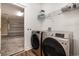 Laundry room with new front-loading washer and dryer with shelving and access to the garage at 6392 Highway 378, Conway, SC 29527