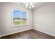 Sunlit dining space showcases wood-look flooring, modern lighting, and a picturesque exterior view at 643 Snowy Owl Way, Conway, SC 29527