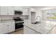 Kitchen featuring stainless steel appliances, granite countertops, a central island and white cabinets at 643 Snowy Owl Way, Conway, SC 29527
