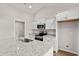 Well-equipped kitchen features stainless steel appliances, granite countertops, island with sink and white cabinets at 643 Snowy Owl Way, Conway, SC 29527