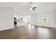Open-concept living area with a ceiling fan, wood-look flooring and natural light from the rear door at 643 Snowy Owl Way, Conway, SC 29527