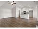 Bright, open-concept living space with vaulted ceilings, modern ceiling fan and wood-look flooring at 643 Snowy Owl Way, Conway, SC 29527