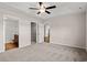 Comfortable main bedroom features neutral carpet, modern ceiling fan, and en-suite bathroom and closet at 643 Snowy Owl Way, Conway, SC 29527