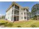 A multi-story building with screened-in balconies showcases a blend of comfort and outdoor living spaces at 646 Tupelo Ln. # 4E, Longs, SC 29568
