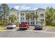 Multi-story building featuring charming balconies and lush landscaping creating an inviting residential atmosphere at 646 Tupelo Ln. # 4E, Longs, SC 29568