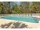 A serene community pool surrounded by mature trees offers a refreshing oasis for residents to unwind and socialize at 646 Tupelo Ln. # 4E, Longs, SC 29568
