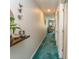 Long carpeted hallway with decoratively furnished shelf and view of the living room at 646 Tupelo Ln. # 4E, Longs, SC 29568