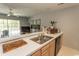 Bright kitchen featuring a stainless steel sink, modern appliances, and a view into the living area at 646 Tupelo Ln. # 4E, Longs, SC 29568