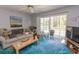 Comfortable living room with sliding glass doors to the balcony and a scenic view of the outdoors at 646 Tupelo Ln. # 4E, Longs, SC 29568