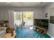 Living room showing sliding door access to a covered balcony overlooking the yard and pool at 646 Tupelo Ln. # 4E, Longs, SC 29568