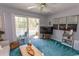 Cozy living room with a ceiling fan, sliding doors to the balcony, and plush blue carpeting at 646 Tupelo Ln. # 4E, Longs, SC 29568