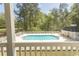 An inviting community pool surrounded by mature trees and meticulously maintained grounds at 646 Tupelo Ln. # 4E, Longs, SC 29568