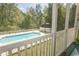 A stunning pool area with a white fence and ample seating, set against a backdrop of lush greenery at 646 Tupelo Ln. # 4E, Longs, SC 29568