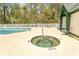 Inviting pool and hot tub area for relaxation and recreation with a secure fence, and a nearby clubhouse at 646 Tupelo Ln. # 4E, Longs, SC 29568