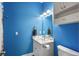 Bathroom featuring blue walls, a marble vanity, and modern fixtures at 679 Riverwalk Dr. # 201, Myrtle Beach, SC 29579