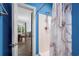 Bathroom with marble shower and blue walls leading into the dining room at 679 Riverwalk Dr. # 201, Myrtle Beach, SC 29579