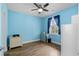 Bedroom featuring light blue walls, hardwood floors, and a ceiling fan at 679 Riverwalk Dr. # 201, Myrtle Beach, SC 29579