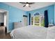 Stylish bedroom with plenty of natural light and a light blue accent wall at 679 Riverwalk Dr. # 201, Myrtle Beach, SC 29579