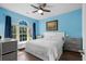 Bright bedroom featuring a window seat, large window, and a ceiling fan at 679 Riverwalk Dr. # 201, Myrtle Beach, SC 29579