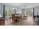 Bright dining area features hardwood floors, glass table, and access to a balcony at 679 Riverwalk Dr. # 201, Myrtle Beach, SC 29579