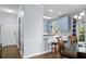 Open-concept kitchen features an arched window, bar seating, and modern pendant lights at 679 Riverwalk Dr. # 201, Myrtle Beach, SC 29579