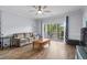Comfortable living room featuring a sliding door to balcony and hardwood floors at 679 Riverwalk Dr. # 201, Myrtle Beach, SC 29579