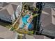 Aerial view of the community pool surrounded by lush landscaping, lounge chairs, and several buildings at 800 Monarch Dr. # 46, Myrtle Beach, SC 29588