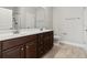 Bathroom featuring a double sink vanity with dark wood cabinets at 800 Monarch Dr. # 46, Myrtle Beach, SC 29588