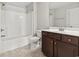 Bright bathroom featuring a shower-tub combo and a dark wood vanity at 800 Monarch Dr. # 46, Myrtle Beach, SC 29588