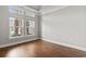 Sunlit room with hard wood floors and large windows with views of a palm tree at 800 Monarch Dr. # 46, Myrtle Beach, SC 29588