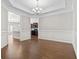 Spacious dining room with hardwood floors, decorative trim and an elegant chandelier at 800 Monarch Dr. # 46, Myrtle Beach, SC 29588
