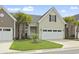 Inviting tan home featuring an attached two-car garage and neat landscaping with palm trees at 800 Monarch Dr. # 46, Myrtle Beach, SC 29588