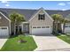 Inviting home featuring well-kept landscaping, an attached garage, and a classic shuttered dormer at 800 Monarch Dr. # 46, Myrtle Beach, SC 29588