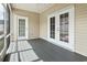 Inviting covered porch featuring neutral siding, grey flooring, and bright double door access to the home at 800 Monarch Dr. # 46, Myrtle Beach, SC 29588