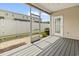 Relaxing screened-in porch with grey wood flooring and a view of the outdoor landscaping at 800 Monarch Dr. # 46, Myrtle Beach, SC 29588