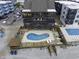 Aerial view of the condo, pool, deck, and beachfront, highlighting the outdoor amenities at 806 N Waccamaw Dr. # 104, Murrells Inlet, SC 29576