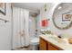 Bathroom featuring a shower-tub combo and decorative mirror at 806 N Waccamaw Dr. # 104, Murrells Inlet, SC 29576