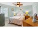 Inviting bedroom with light blue walls, ceiling fan, and tiled flooring at 806 N Waccamaw Dr. # 104, Murrells Inlet, SC 29576