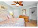 Well-lit bedroom with ceiling fan, dresser and an ensuite bathroom at 806 N Waccamaw Dr. # 104, Murrells Inlet, SC 29576