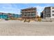 Gorgeous condo building exterior sitting on the beach with private beach access and parking at 806 N Waccamaw Dr. # 104, Murrells Inlet, SC 29576