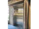 An elevator in a residential building with a metal door, next to a support beam at 806 N Waccamaw Dr. # 104, Murrells Inlet, SC 29576