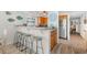 Kitchen with breakfast bar featuring granite countertops, wooden cabinets, and stainless steel appliances at 806 N Waccamaw Dr. # 104, Murrells Inlet, SC 29576
