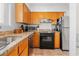 Kitchen with granite countertops, stainless steel appliances, and natural wood cabinetry at 806 N Waccamaw Dr. # 104, Murrells Inlet, SC 29576
