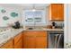 Bright kitchen featuring granite countertops, stainless steel appliances, and wooden cabinetry at 806 N Waccamaw Dr. # 104, Murrells Inlet, SC 29576